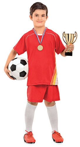 A smiling boy in a red soccer uniform holds a soccer ball in one hand and a gold trophy in the other. He’s wearing a medal around his neck.