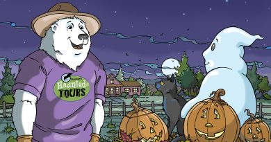 A friendly polar bear, Boomer wears a hat and purple shirt standing by a wagon full of pumpkins, with a ghost, black cat, and spooky Halloween decorations nearby.