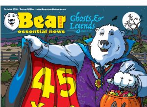 Bear Essential News October 2026 Edition. Boomer, a polar bear dressed as Dracula holds open a red cape that says “45 Years” and a pumpkin candy bucket on a spooky night.