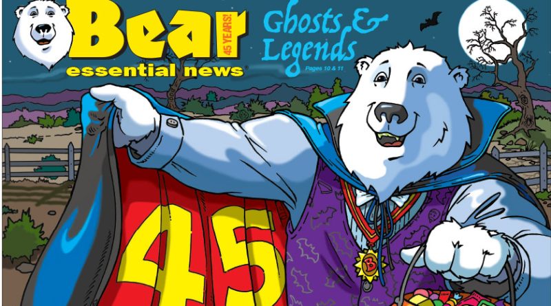 Bear Essential News October 2026 Edition. Boomer, a polar bear dressed as Dracula holds open a red cape that says “45 Years” and a pumpkin candy bucket on a spooky night.
