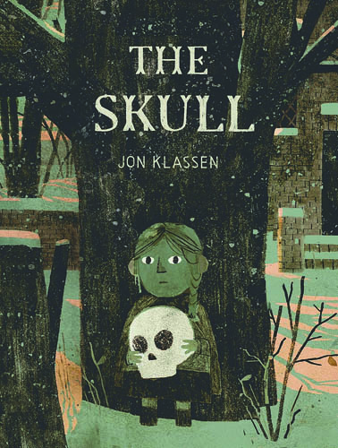 Book cover of The Skull by Jon Klassen. A girl with braids stands by a big tree in a dark forest, holding a white skull with large black eye holes.